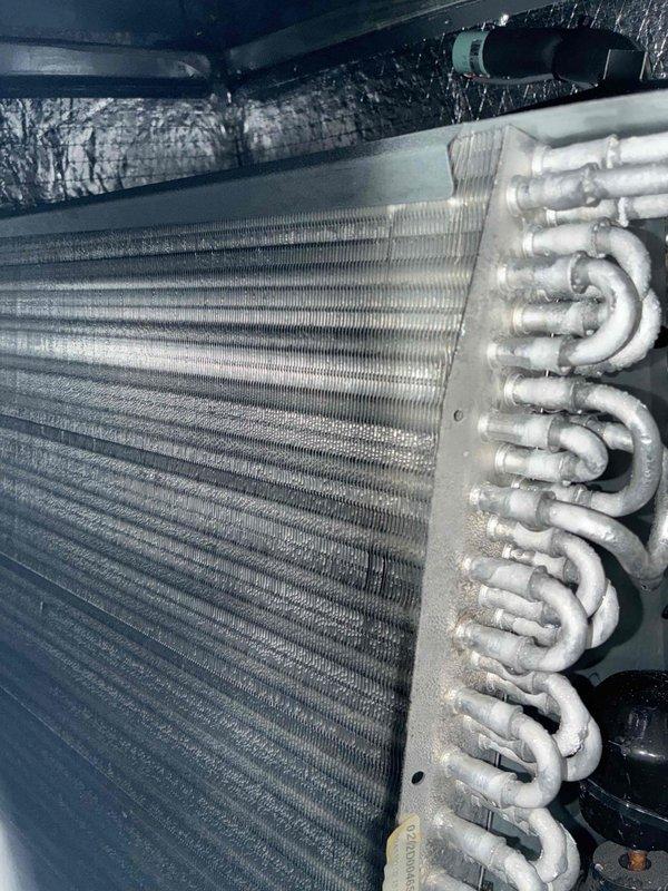 Completed routine cooling maintenance visit on residential HVAC system. Inspected evaporator coil assembly located in attic space, noting dust and dirt accumulation on aluminum fins and copper refrigerant lines. Verified system temperature differential reading of 50.0°F, confirming proper cooling operation and refrigerant charge levels.