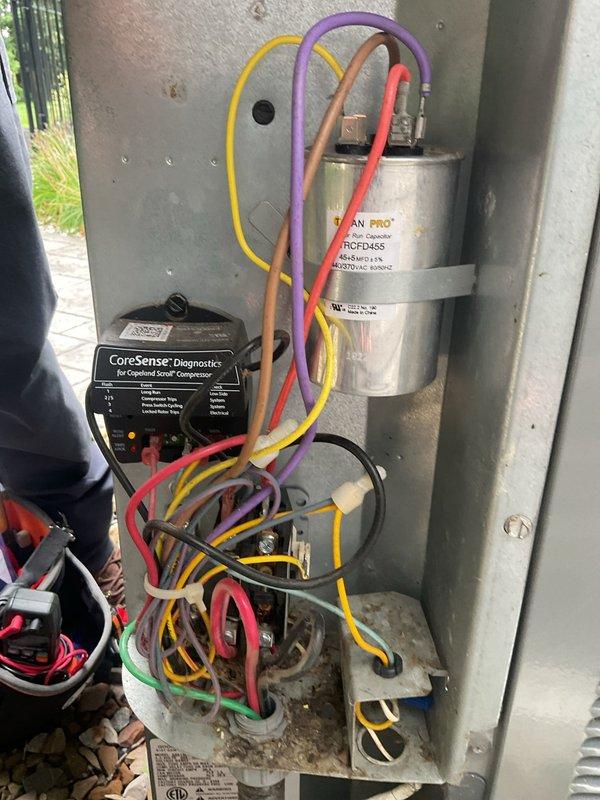 Completed routine cooling system maintenance on P.K. Wadsworth HVAC unit. Inspected and replaced air filters, verified electrical connections and capacitor operation, and examined CoreSense diagnostic system on Copeland scroll compressor. All components found operating within normal parameters with no immediate service needs identified.