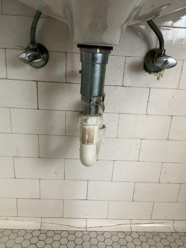 Responded to service call for leaky faucet and shut-off valve replacement at residential bathroom sink. Upon inspection, identified worn compression fittings on existing chrome angle stop valves beneath pedestal-style sink with three-handle faucet configuration. Replaced both hot and cold water supply shut-off valves with new quarter-turn angle stops to provide reliable water control and eliminate potential leak points. Verified proper connection of braided supply lines to new valves and tested for leaks under pressure. Addressed minor dripping from faucet assembly and confirmed all fixtures operating properly upon completion.