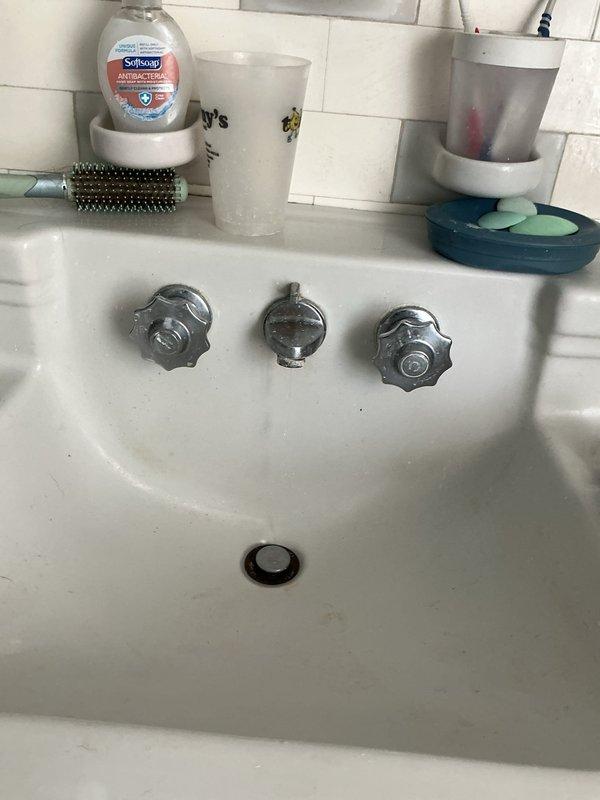 Responded to service call for leaky faucet and shut-off valve replacement at residential bathroom sink. Upon inspection, identified worn compression fittings on existing chrome angle stop valves beneath pedestal-style sink with three-handle faucet configuration. Replaced both hot and cold water supply shut-off valves with new quarter-turn angle stops to provide reliable water control and eliminate potential leak points. Verified proper connection of braided supply lines to new valves and tested for leaks under pressure. Addressed minor dripping from faucet assembly and confirmed all fixtures operating properly upon completion.