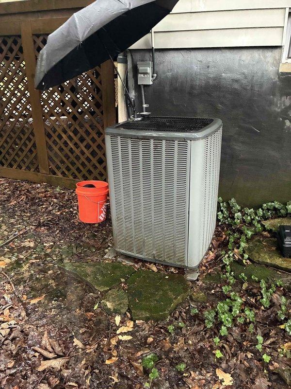 # HVAC Cooling Maintenance Summary

Completed scheduled preventive maintenance on residential air conditioning system as part of ongoing cooling season service plan. Performed comprehensive inspection of outdoor condenser unit and refrigerant line connections, verifying proper operation of all mechanical and electrical components. System found to be operating within normal parameters with no immediate service needs identified.

# Detailed Work Performed

Conducted thorough visual and operational inspection of split-system air conditioning equipment. Examined outdoor condensing unit positioned on concrete pad at exterior of residence. Assessed overall condition of equipment housing, noting accumulation of organic debris and vegetation growth around unit perimeter and on mounting surface.

Inspected refrigerant line connections and suction/liquid line assembly, verifying integrity of insulation and copper tubing. Examined mechanical fittings, compression connections, and associated hardw