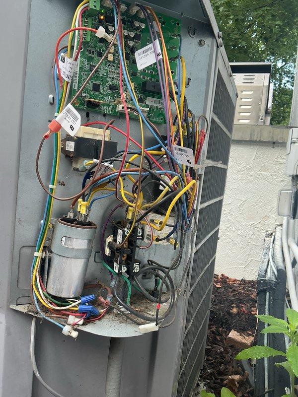 Responded to complaint of inadequate cooling in one room. Performed system assessment and inspection of outdoor condensing unit. Found condenser coil obstructed with debris including grass clippings, twigs, and organic material lodged between fins, restricting airflow and reducing heat transfer efficiency. Inspected electrical components, control boards, and capacitor—all appeared functional with proper wiring connections intact. Documented unit condition with photographs showing debris accumulation on coil and internal component layout. Provided assessment findings and recommended professional coil cleaning to restore proper airflow and system performance, along with evaluation of ductwork and airflow balance to affected room to determine if additional measures such as damper adjustments or supplemental air circulation would be beneficial.