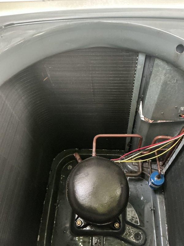 Replaced failed condenser fan motor and dual run capacitor on Amana outdoor unit. Performed thorough condenser coil cleaning to restore proper airflow and heat transfer efficiency, removing accumulated debris and contaminants from coil fins and unit interior.