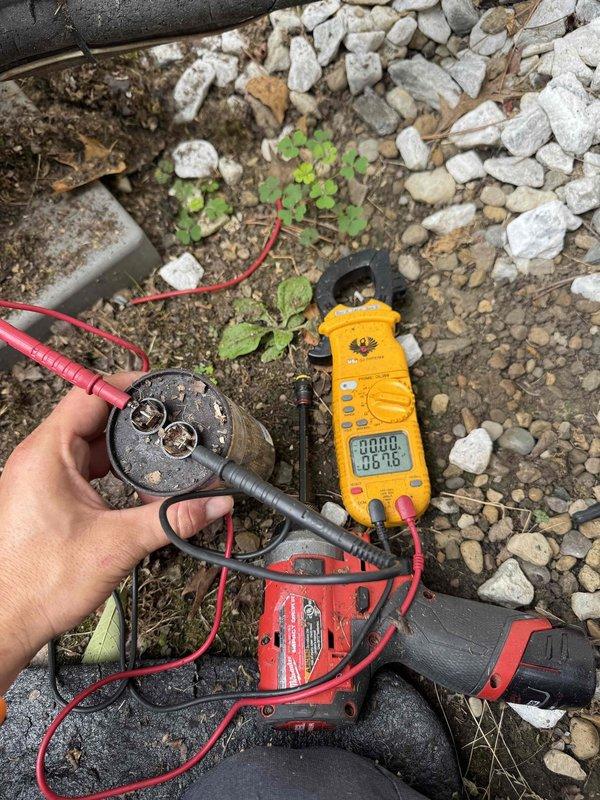 Responded to service call for outdoor condensing unit with slow motor rotation and insufficient compression. Upon inspection, diagnosed failed run capacitor causing reduced motor speed and compromised compressor operation. Removed defective capacitor, tested electrical readings with clamp meter to verify proper voltage and amperage, and installed new replacement capacitor. Verified proper motor operation and compressor function upon startup, restoring unit to normal operating condition.