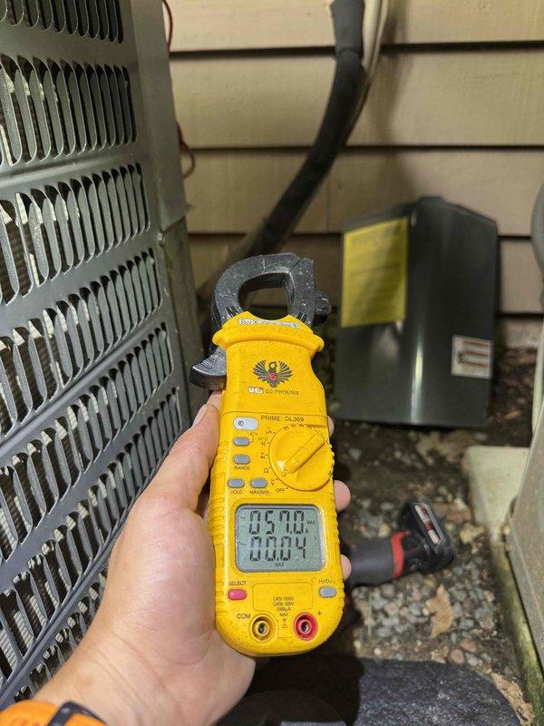 Completed routine HVAC cooling maintenance on outdoor condensing unit. Performed electrical diagnostics using clamp meter to verify proper amperage draw and system operation, inspected capacitor and contactor connections with all wiring in good condition, and documented equipment status through service photography.