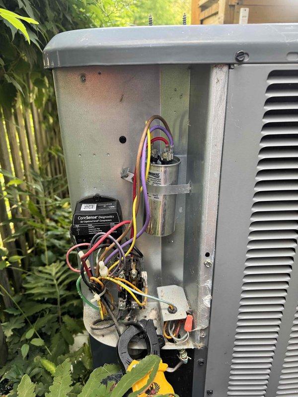 Responded to no cooling call on residential air conditioning system. Upon arrival, accessed outdoor condenser unit and inspected electrical components including capacitor and ComSense hard start kit. All electrical connections and components were found to be functioning properly with no visible defects or failures. Unit operational at time of inspection.