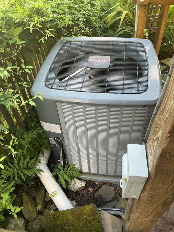Responded to no cooling call on residential air conditioning system. Upon arrival, accessed outdoor condenser unit and inspected electrical components including capacitor and ComSense hard start kit. All electrical connections and components were found to be functioning properly with no visible defects or failures. Unit operational at time of inspection.