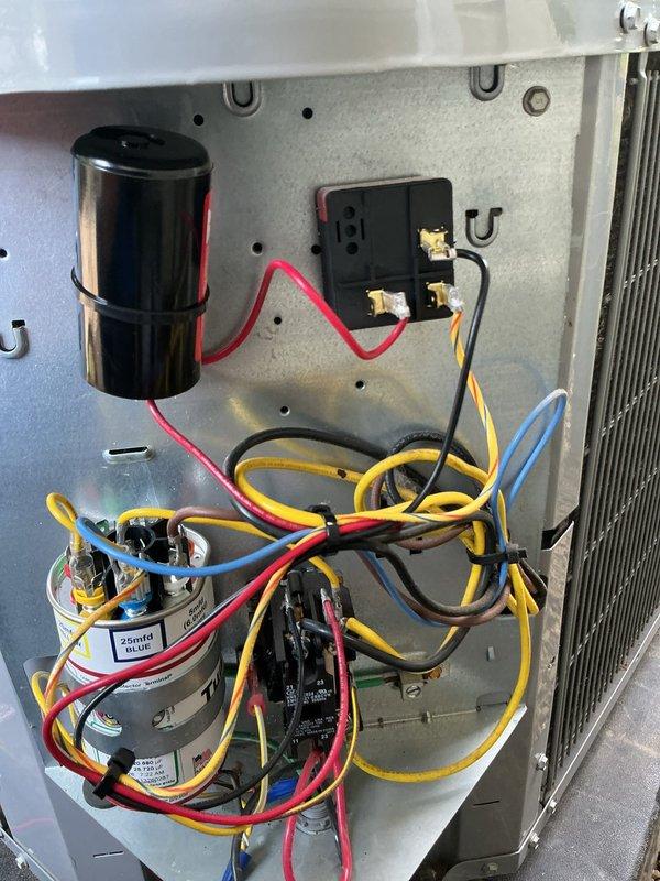 Responded to emergency service call for smoking outdoor unit following recent hard start kit installation by another technician. Upon arrival, inspected electrical components and found improper hard start kit installation creating hazardous condition. Removed incorrectly installed hard start kit, verified all electrical connections at compressor contactor, dual run capacitor, and associated wiring. System restored to proper operating configuration with all factory-specified components. Unit tested and confirmed safe operation with no smoking or electrical issues. Documented equipment condition with photos showing proper capacitor and contactor arrangement.