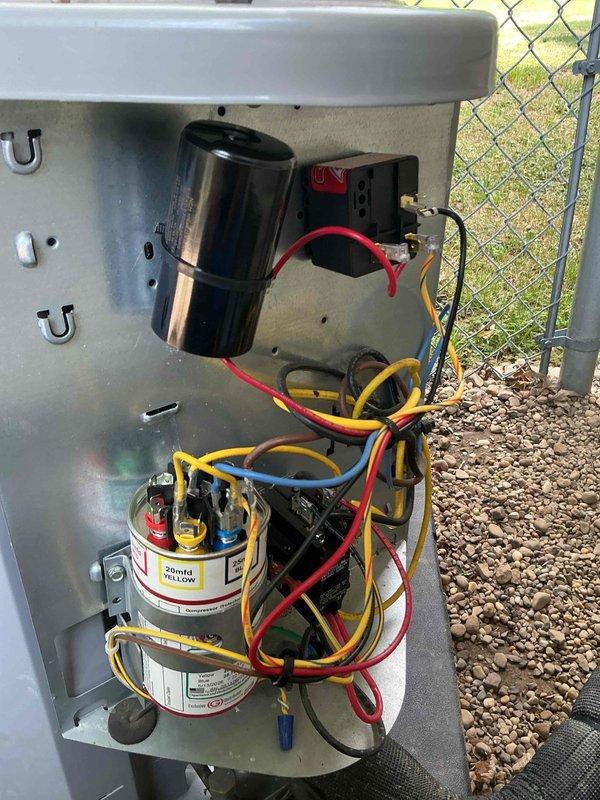 Responded to emergency service call for smoking outdoor unit following recent hard start kit installation by another technician. Upon arrival, inspected electrical components and found improper hard start kit installation creating hazardous condition. Removed incorrectly installed hard start kit, verified all electrical connections at compressor contactor, dual run capacitor, and associated wiring. System restored to proper operating configuration with all factory-specified components. Unit tested and confirmed safe operation with no smoking or electrical issues. Documented equipment condition with photos showing proper capacitor and contactor arrangement.