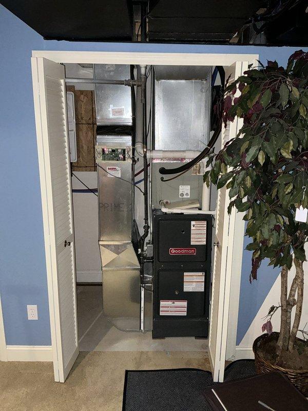 Completed comprehensive HVAC estimate for replacing two existing air conditioning systems with a single zoned system configuration. Evaluated current setup including two outdoor condenser units mounted on exterior wall with weathered siding and existing Goodman furnace in mechanical room, assessed equipment condition and installation requirements for consolidating to one efficient zoned system with appropriate ductwork modifications.
