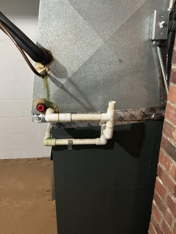 Responded to service call for water leak on one-year-old furnace installation. Upon inspection, identified condensate drainage issue affecting the HVAC air handler unit. Examined PVC condensate drain line configuration and trap assembly for proper pitch and blockages. Assessed moisture damage on concrete floor beneath unit, indicating ongoing leak condition. Verified condensate pump operation and drain line routing. Cleared blockage in condensate system and confirmed proper drainage flow. Tested unit operation to ensure leak was resolved and condensate removal functioning correctly.