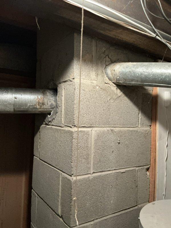 Conducted on-site evaluation of non-functional residential air conditioning system in basement utility area. Inspected existing HVAC equipment, ductwork, refrigerant lines, and electrical connections to assess system condition and replacement requirements. Documented equipment configuration including furnace panel, copper refrigerant lines with insulation, vertical conduit, and galvanized metal ductwork. Evaluated installation space, structural considerations, and utility access points to determine optimal replacement system specifications and installation approach for complete cooling system replacement estimate.