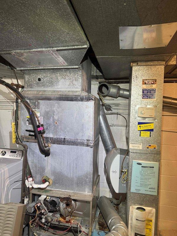 Responded to service call for reported refrigerant leak in residential air conditioning system. Upon arrival, performed comprehensive visual inspection of HVAC equipment located in basement mechanical room. Examined air handler unit, associated ductwork connections, and refrigerant lines for signs of leakage. Conducted leak detection procedures on copper tubing, coil components, and mechanical connections. Inspected air filter condition and found contamination requiring replacement. Removed dirty air filter from system and installed new filter media to restore proper airflow and system efficiency. Documented equipment condition through photographic records showing air handler installation, ductwork configuration, and filter replacement. System requires follow-up refrigerant leak repair to restore full cooling capacity.