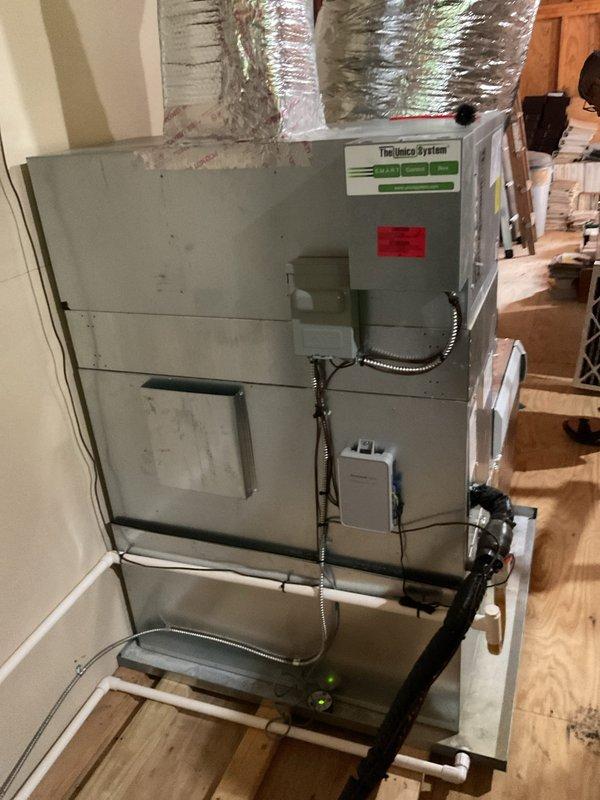 Performed comprehensive cooling system tune-up on residential air handler unit. Inspected blower motor assembly, noting dust accumulation on housing and cover plate; verified electrical connections and wire bundles for proper operation. Examined ductwork connections, condensate drain line, and overall system installation; provided customer with information regarding maintenance plan options and system performance optimization.