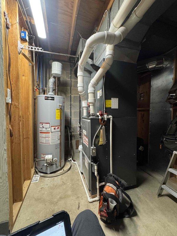 Responded to complaint of loud blower fan operation on residential air conditioning system. Performed diagnostic inspection of HVAC unit and blower assembly. Measured supply air temperature at 53.3°F, confirming adequate cooling performance. Inspected furnace/air handler unit, ductwork connections, and blower motor for abnormal noise sources. Documented equipment conditions with condensation present on evaporator coil access panel, indicating normal system operation. No immediate mechanical failures identified during inspection.