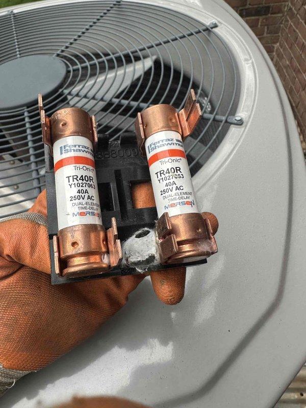 Completed scheduled preventive maintenance on residential cooling system. Inspected and replaced two heavily corroded TR40R 40-amp 250V AC fuses in the outdoor condensing unit. Identified failed dual-run capacitor (440/370VAC) exhibiting severe rust and corrosion on terminal assembly and replaced with new component to restore proper compressor and condenser fan motor operation.