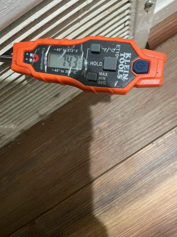 Completed routine cooling system maintenance inspection on residential HVAC unit. Performed temperature diagnostics using calibrated digital thermometer, recording discharge air temperature of 193°F at the outdoor condensing unit. Verified proper operation of air quality monitoring equipment and confirmed all safety labels and caution notices remain visible and legible on equipment. System operating within normal parameters with no deficiencies noted during this scheduled preventive maintenance visit.
