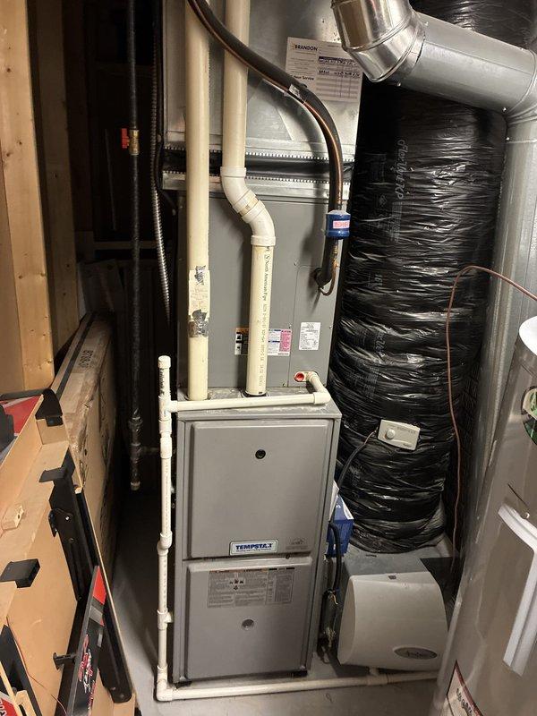 Presented customer with multiple equipment replacement options including individual AC unit replacement and complete HVAC system upgrade. Evaluated existing Tempstar furnace installation with connected ductwork, condensate drainage system, and residential air ionization system. Documented current equipment configuration including flexible ductwork, PVC venting, and accessory components to provide accurate replacement recommendations.