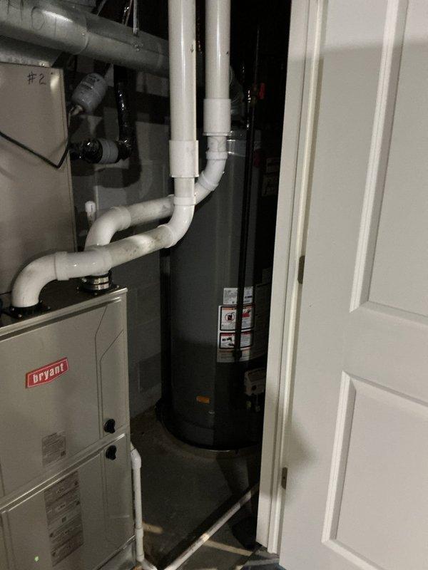 Conducted comprehensive assessment of existing Bryant HVAC system and water heater installation located in interior mechanical closet. Documented current equipment condition, including air handler with visible dust accumulation on interior surfaces, condensate drain line configuration, and overall system accessibility. Evaluated replacement options and provided customer with equipment upgrade recommendations based on existing installation parameters and spatial constraints.