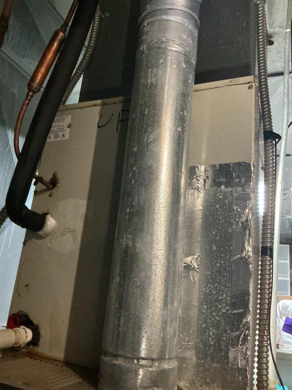 Responded to customer complaint of air conditioning system running but not cooling, with indoor temperature reading 78°F despite thermostat set to 69°F. Inspected dual Trane HVAC unit installation in mechanical room, examining equipment operation, ductwork connections, and system components. Documented system configuration and current operating conditions with tagged equipment for reference.
