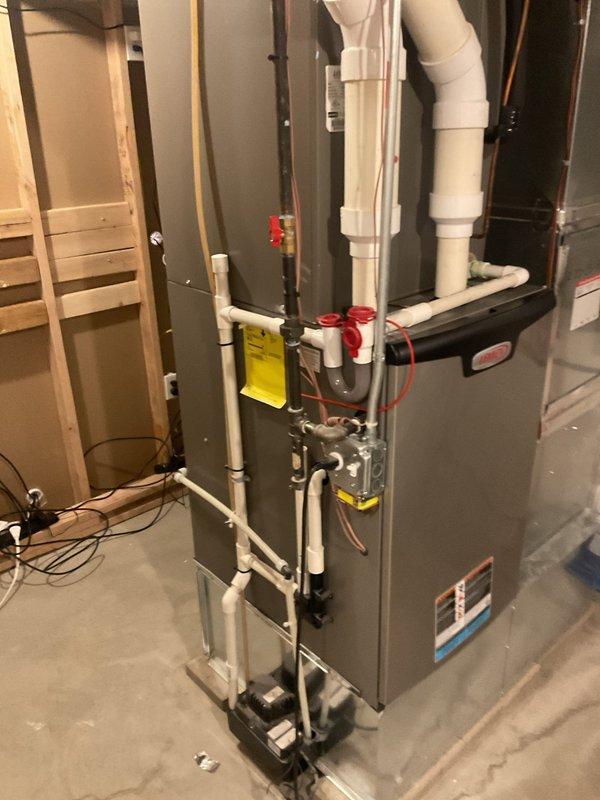 Completed seasonal cooling maintenance on Lennox air conditioning system and furnace unit. Performed comprehensive inspection of outdoor condensing unit, verified proper operation of compressor and condenser fan motor, checked refrigerant levels and electrical connections. Inspected indoor furnace cabinet and associated components including PVC vent piping, condensate drain system, and refrigerant line connections. All equipment found operating within normal parameters with no deficiencies noted.