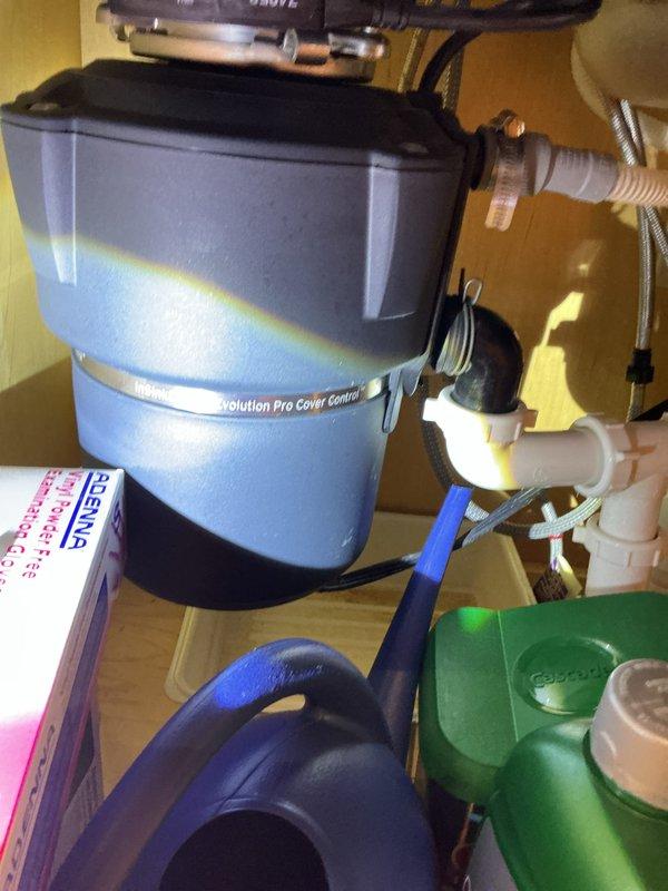 Completed courtesy plumbing inspection of utility area and kitchen sink installation. Inspected electrical junction box, water heater connections, supply lines, and shutoff valves in mechanical room—all components functioning properly with no leaks detected. Evaluated under-sink water treatment system including Evolution Pro water softener unit, filtration components, and associated plumbing connections; verified proper operation and identified no immediate service needs.