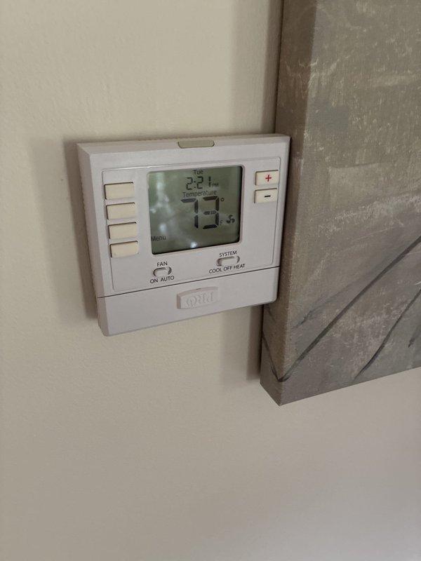 Completed estimate for full HVAC system replacement at residential property with easy access conditions. Assessed existing equipment including wall-mounted programmable thermostat, exterior refrigerant lines with deteriorating insulation, and condensing unit location showing aged pipe penetrations through vinyl siding with visible staining and compromised sealing. Documented current system configuration and provided recommendations for complete dual-system replacement to address equipment age, efficiency concerns, and exterior component degradation.