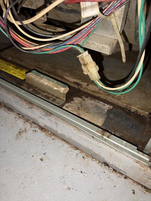 Completed routine maintenance visit on aging air conditioning system as part of ongoing preventive maintenance program. Upon inspection, found significant dust, dirt, and cobweb accumulation throughout unit interior, including on compressor housing, evaporator coil fins, and electrical components. Documented equipment condition through photographic evidence showing debris buildup on heat exchanger coils and various mechanical components, which can reduce system efficiency and airflow if left unaddressed.