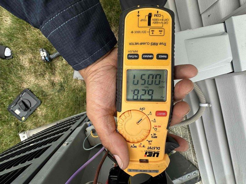 Performed comprehensive cooling system maintenance on outdoor condensing unit. Conducted electrical diagnostics using digital multimeter, measuring voltage and amperage readings to verify proper system operation and component performance. All measurements indicated equipment operating within normal parameters. Unit inspected and confirmed functioning properly.