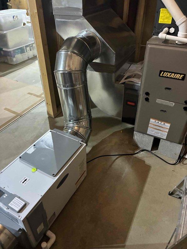 Returned to complete installation of whole home dehumidifier system integrated with existing Luxaire furnace and HVAC infrastructure. Connected dehumidifier unit to main supply plenum using properly sized metallic ductwork with appropriate elbow configurations, ensuring optimal airflow distribution throughout the system. Installed condensate drainage lines using PVC piping routed to floor drain, verified all electrical connections, tested unit operation for proper humidity control functionality, and confirmed system integration with existing heating and cooling equipment operates as designed.