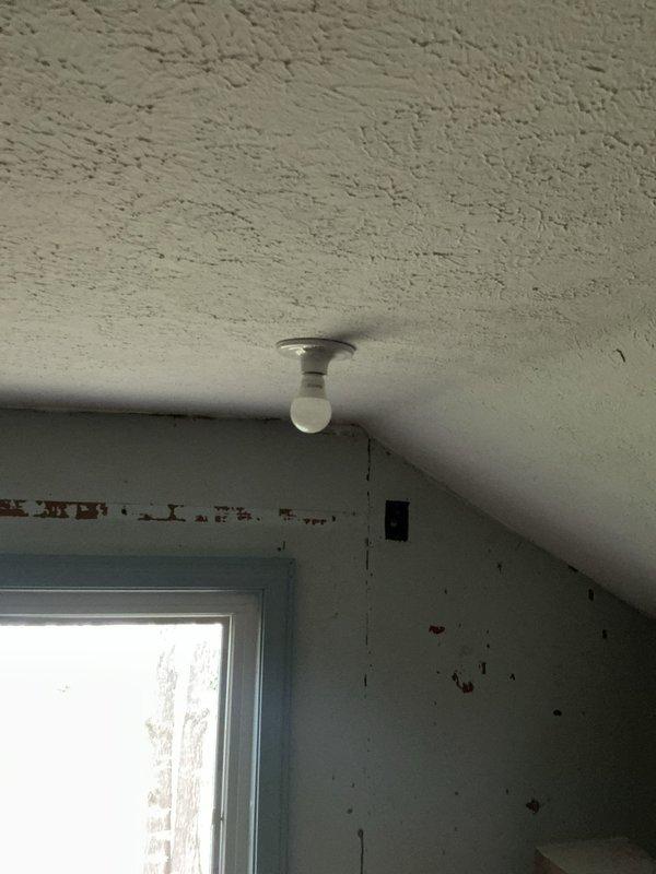 Completed installation of electrical fixtures in residential property. Replaced ceiling-mounted light fixture with dome-style frosted glass fixture in room with textured ceiling. Verified proper electrical connections and tested outlet functionality in adjacent room with window exposure. All work performed to code specifications with fixtures operating correctly upon completion.