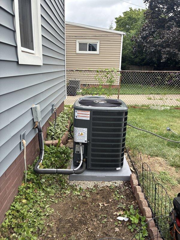 Completed full HVAC system installation including 80% efficiency furnace, air conditioning condenser unit, and whole-home humidifier. New outdoor condenser unit was positioned on concrete pad with proper clearances, refrigerant lines and electrical conduit were run through exterior wall penetration, and all connections were properly sealed and secured. Interior furnace and humidifier components were integrated into existing ductwork system to provide complete climate control solution.