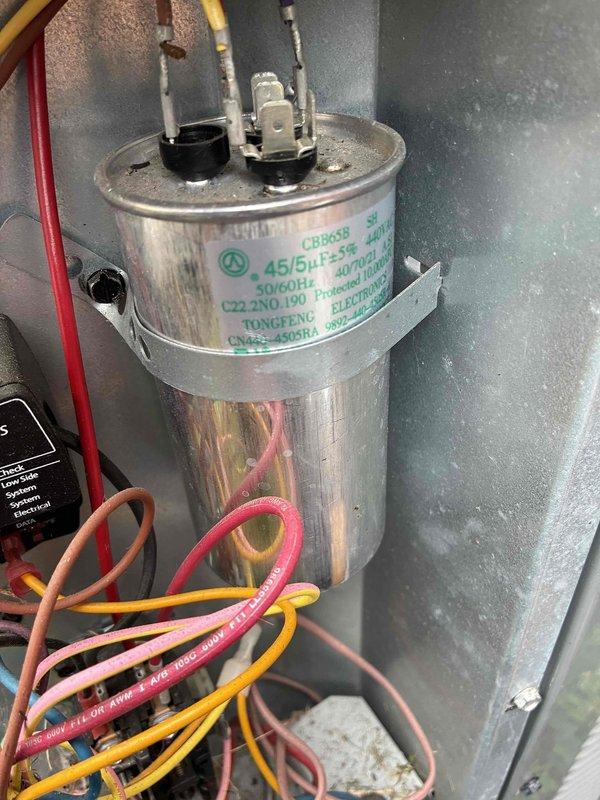 Completed routine maintenance on HVAC cooling system, inspecting and verifying proper operation of dual-run capacitor (45/5µF) and fuse disconnect assembly with copper fuses. All electrical components tested and confirmed to be functioning within manufacturer specifications, ensuring continued reliable system performance.