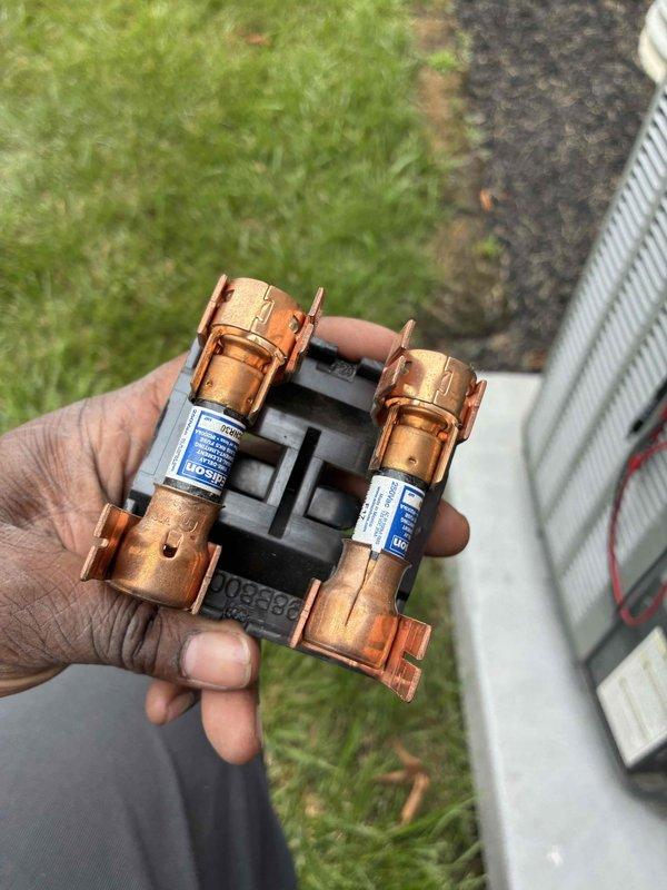 Completed routine maintenance on HVAC cooling system, inspecting and verifying proper operation of dual-run capacitor (45/5µF) and fuse disconnect assembly with copper fuses. All electrical components tested and confirmed to be functioning within manufacturer specifications, ensuring continued reliable system performance.