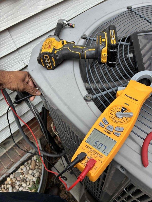 Completed scheduled preventive maintenance on residential air conditioning system. Performed electrical diagnostics on outdoor condenser unit using digital multimeter, recording voltage readings of 59.2 to verify proper power supply and system operation. Inspected blower motor assembly, noting dust and debris accumulation on motor housing and cooling fins that required attention for optimal heat dissipation and equipment longevity. All components assessed for proper function and system confirmed operational.