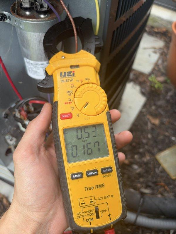 # HVAC Cooling Maintenance Completed

Performed comprehensive cooling system maintenance on residential split-system air conditioning unit. Conducted electrical diagnostics using digital clamp meter, measuring compressor amperage draw at 145.2 amps and verifying proper electrical performance with readings of 0.187 on secondary display. Inspected outdoor condenser unit components including capacitor, contactor, and refrigerant lines for proper operation. Evaluated indoor furnace/air handler unit and associated ductwork system to ensure proper airflow and system integration. All equipment found operating within normal parameters with no deficiencies noted.