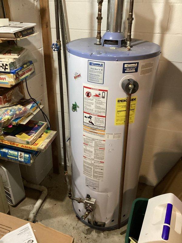 Conducted on-site evaluation for tankless water heater replacement. Assessed existing conventional storage tank water heater installation in basement utility area, including current plumbing connections, venting configuration, and available space for potential tankless unit installation. Documented existing setup showing water supply lines, pressure relief valve piping, shut-off valves, and gas or electrical connections to determine conversion requirements and provide accurate estimate for tankless water heater system upgrade.