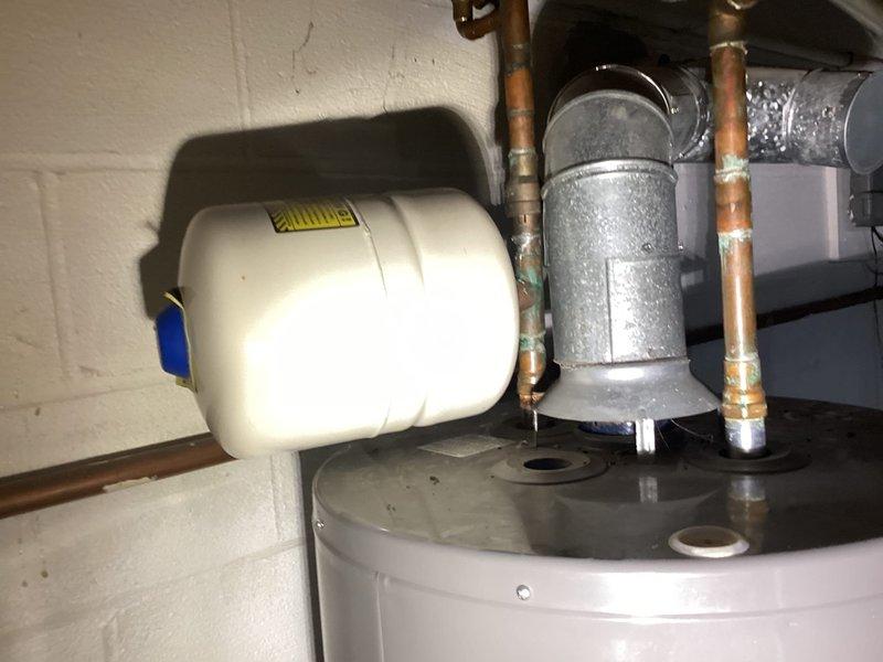 Responded to no hot water complaint following previous service visit. Upon arrival, inspected Rheem Classic series professional-grade tanked water heater and associated plumbing connections. Evaluated all top-mounted components including temperature and pressure relief valve, expansion tank with proper air charge, circulator assembly, and copper supply lines showing age-related oxidation. Diagnosed issue and restored hot water functionality to the system.