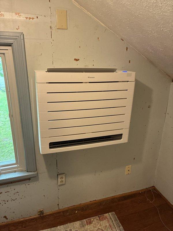 Completed installation of Daikin ductless mini-split system in upper-level interior space. Mounted indoor air handler unit on wall with proper clearances, ran refrigerant lines to outdoor condenser, and verified system pressures at 15.0 PSI. Electrical connections were completed as part of the installation, and system was tested for proper operation.