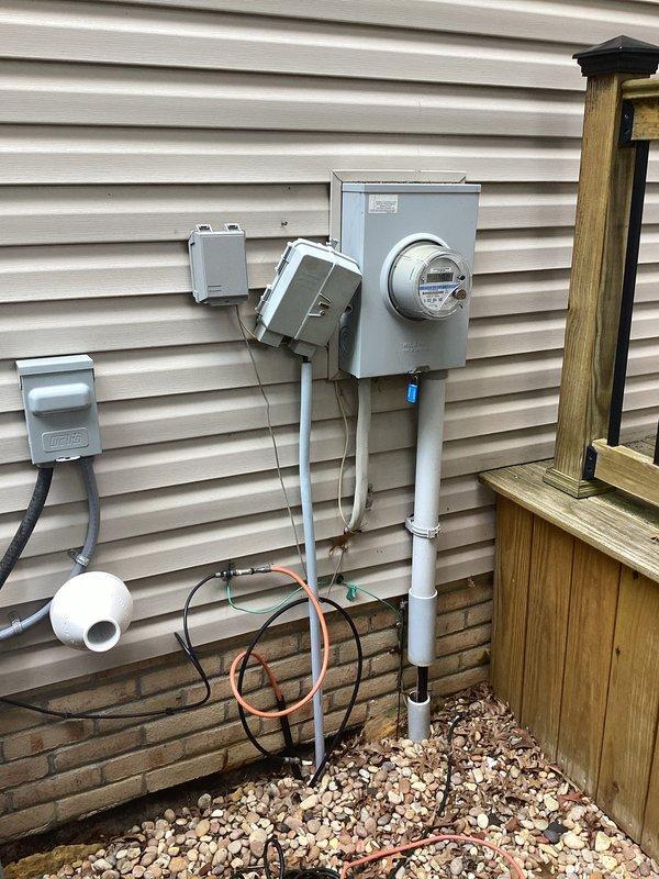 Conducted on-site evaluation for Generac generator installation at residential property. Assessed existing electrical service panel, meter configuration, and utility connections on exterior wall to determine optimal generator placement and integration requirements. Documented current electrical infrastructure including main service disconnect, digital meter assembly, and associated conduit routing. Evaluated proposed installation location measuring clearances from structure, confirming minimum 2-foot offset from building exterior per manufacturer specifications and local code requirements. Photographed existing utility setup including gas meter, electrical panels, and available mounting surfaces to develop comprehensive installation plan. Assessment included review of load requirements, transfer switch placement options, and necessary permits for permanent standby generator system installation.