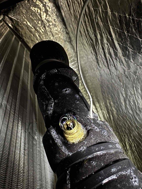 # Warranty Service Completed

Responded to warranty service call for R-32 refrigerant recharge on residential HVAC system. Upon arrival, discovered significant condensation and frost accumulation on flexible ductwork in attic space, indicating low refrigerant charge causing excessive temperature drop across evaporator coil. Inspected refrigerant lines and confirmed system was operating below optimal pressure levels.

Accessed refrigeration circuit connections and recharged system with R-32 refrigerant to manufacturer specifications. Verified proper pressures on both high and low sides of system. Monitored system operation to ensure condensation issue resolved and ductwork returned to normal operating temperatures. System restored to proper cooling capacity under warranty coverage.