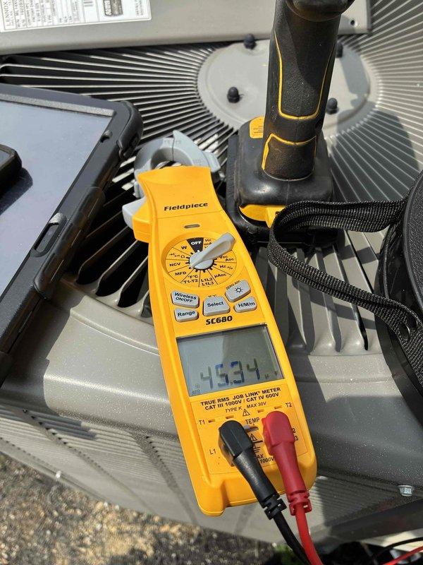 Completed scheduled cooling maintenance on HVAC system. Performed diagnostic testing including supply air temperature verification at 53°F and electrical parameter measurements reading 45.34 on multimeter. Inspected condenser/evaporator coils and confirmed system operating within normal specifications.