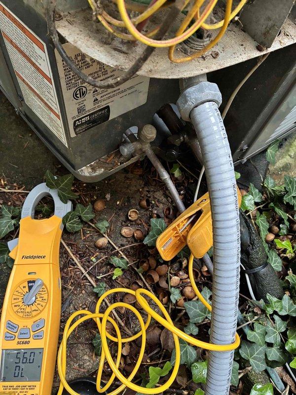 Performed comprehensive cooling system maintenance on outdoor HVAC unit. Conducted diagnostic testing using digital manifold gauges, measuring system pressures and verifying refrigerant charge levels at 568 PSI. Inspected electrical connections, wiring harnesses, and conduit routing for proper operation. Evaluated indoor air handler and return air grille for adequate airflow and cleanliness. System operating within normal parameters upon completion.