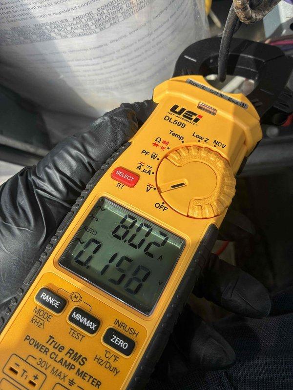 Responded to commercial no-cool complaint on rooftop unit. Performed electrical diagnostics using digital multimeter, measuring voltage and amperage readings on system components. Readings indicated 12.68V and 2A on tested circuits, with additional measurements showing 508 on clamp meter display during troubleshooting of the non-functioning air conditioning unit.