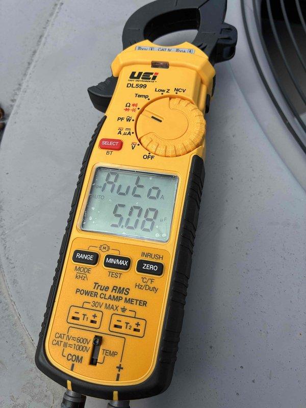Responded to commercial no-cool complaint on rooftop unit. Performed electrical diagnostics using digital multimeter, measuring voltage and amperage readings on system components. Readings indicated 12.68V and 2A on tested circuits, with additional measurements showing 508 on clamp meter display during troubleshooting of the non-functioning air conditioning unit.