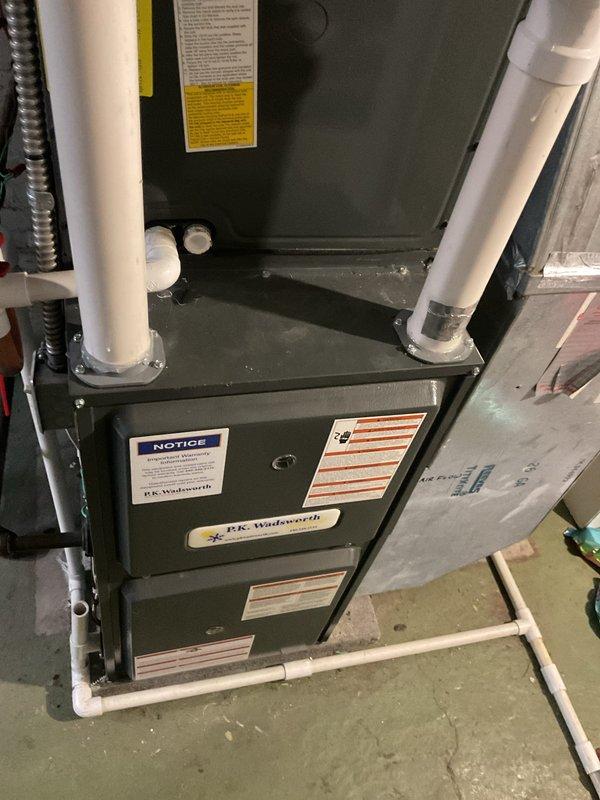 Completed routine HVAC cooling system maintenance on residential furnace unit with integrated cooling components. Performed standard inspection procedures, verified proper airflow with supply temperature reading of 51°F, and confirmed all safety labels and ventilation piping connections were intact and functioning correctly.