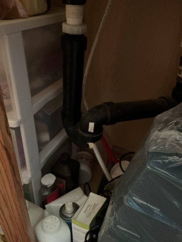 Completed whole home plumbing inspection addressing reported clogs in toilet and bathtub, along with assessment of undetermined leak location. Inspected under-sink plumbing assembly revealing drain pipe with visible repairs or modifications, documented cluttered storage area surrounding plumbing components for access concerns. Examined toilet tank internals showing deteriorated flush mechanism with significant rust accumulation, corroded flapper valve, and aged fill valve assembly requiring attention. Documented conditions and provided findings to customer for repair recommendations.