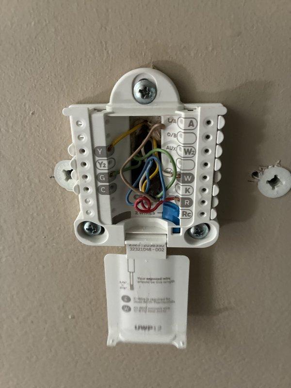 Conducted on-site evaluation of existing forced air cooling system to provide replacement options. Assessed outdoor condenser unit condition, age, and operational status, noting unit positioning relative to electrical service and property layout. Inspected indoor thermostat wiring configuration and terminal connections to determine compatibility requirements for new equipment installation. Documented current system specifications and site conditions through photographic records. Provided homeowner with comprehensive replacement options for complete HVAC system upgrade.