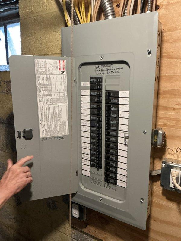 Conducted comprehensive site assessment for standby generator installation at residential property. Evaluated existing electrical service infrastructure including main distribution panel, utility meter assembly, and disconnect equipment mounted on exterior wall. Documented current electrical configuration with multiple conduits and service entrance components to determine generator integration requirements.

Inspected interior subpanel installation in basement utility area, noting existing circuit layout and available capacity for generator connection. Assessed grounding system, service feed routing, and panel configuration to establish proper automatic transfer switch placement and load management strategy for emergency backup power system.