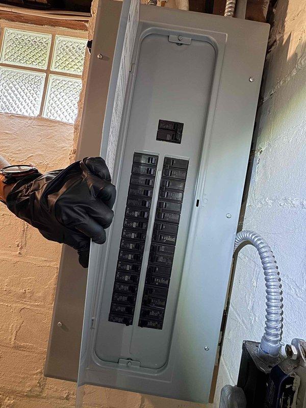 Completed preventive maintenance on aging outdoor cooling system. Inspected cylindrical condenser coil assembly, verified refrigerant line connections, and confirmed proper electrical circuit breaker operation at main panel. Unit operational with no immediate repairs required.